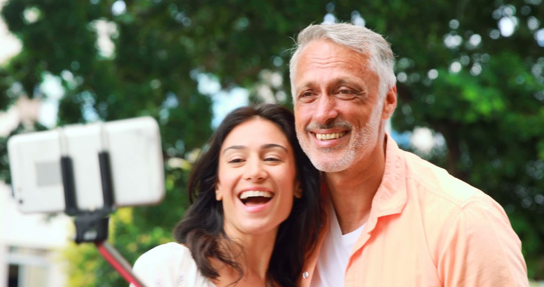 Smiling Couple Taking Selfie Outdoors - Free Images, Stock Photos and Pictures on Pikwizard.com