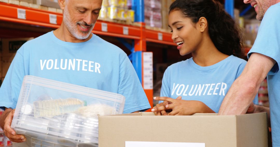 Diverse Volunteers Packing Food in Warehouse for Charity - Free Images, Stock Photos and Pictures on Pikwizard.com