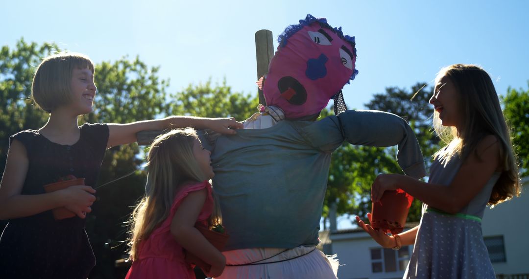 Children Engaging with Scarecrow During Summer Day - Free Images, Stock Photos and Pictures on Pikwizard.com