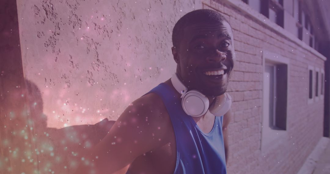 Energetic Man Smiling with Headphones and Glow Effects