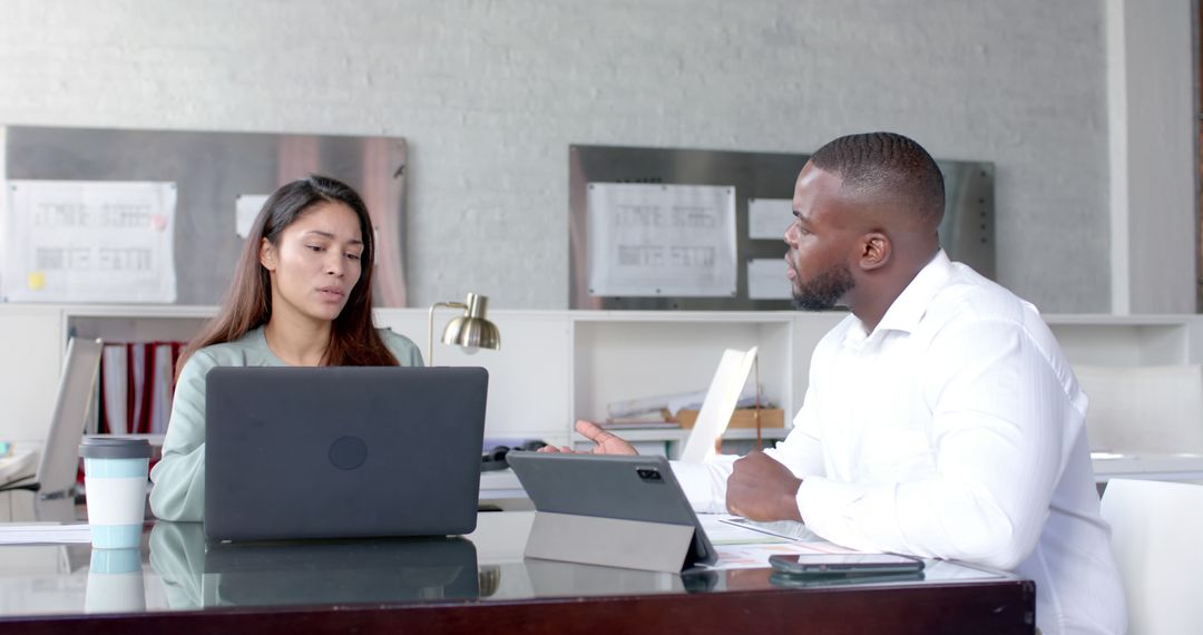 Diverse Colleagues Discussing Project in Casual Office Environment