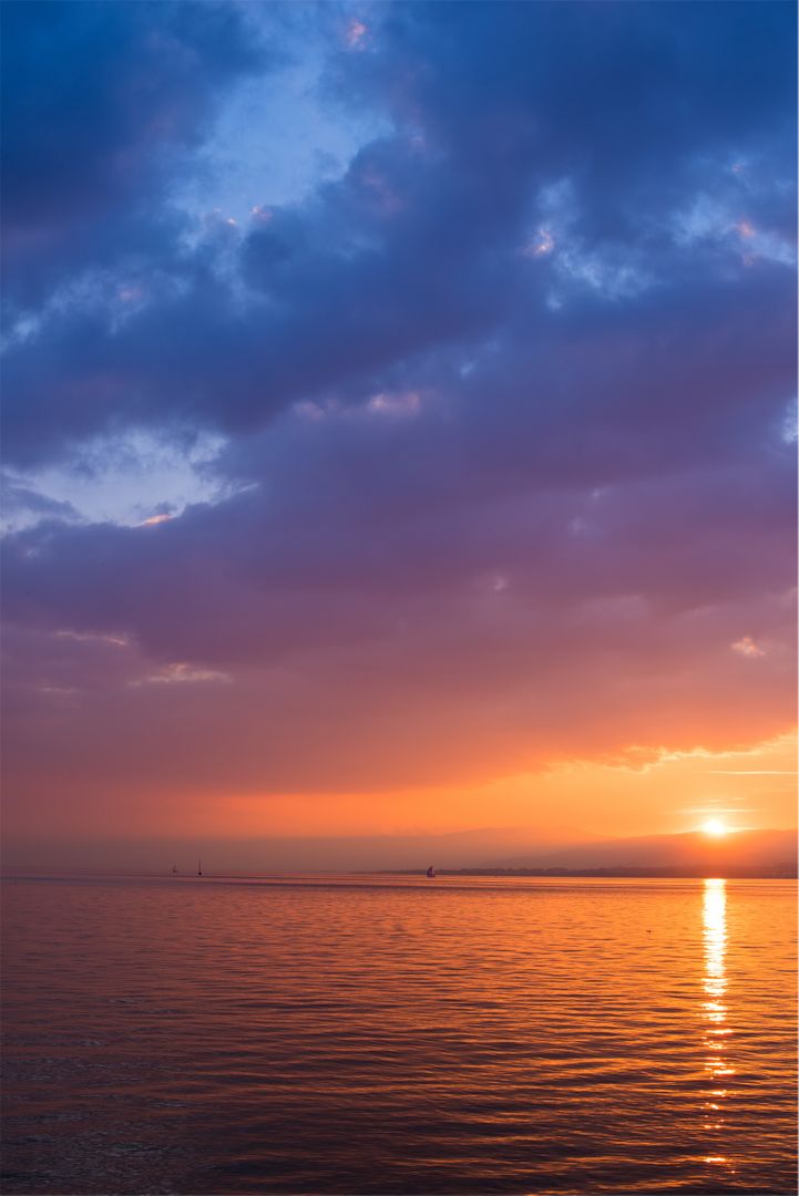 Stunning Sunset Over Calm Ocean with Orange and Purple Sky - Free Images, Stock Photos and Pictures on Pikwizard.com