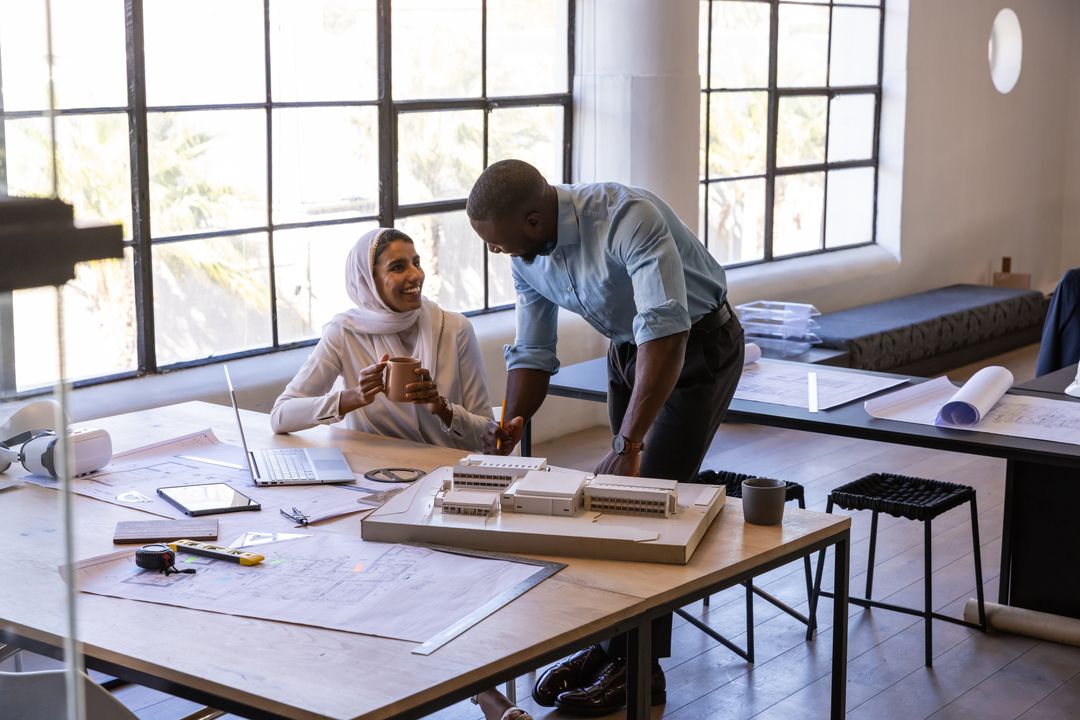 Diverse Team Collaborating Over Models and Blueprints in Modern Studio