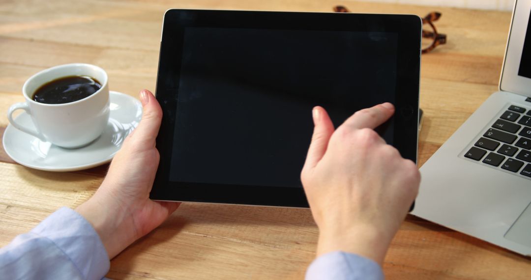 Using Tablet with Coffee and Laptop on Wooden Desk - Free Images, Stock Photos and Pictures on Pikwizard.com