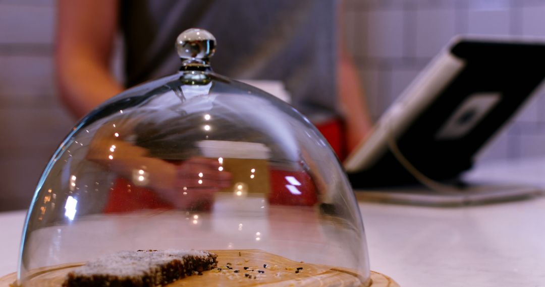 Barista Working at Coffee Shop Counter with Pastry Under Glass Dome - Free Images, Stock Photos and Pictures on Pikwizard.com