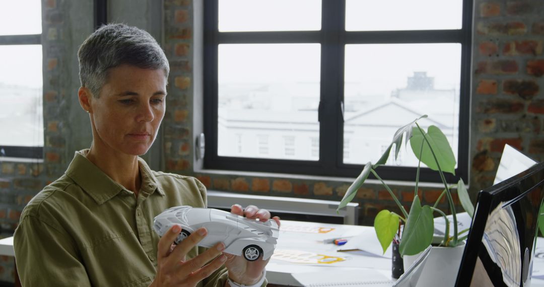 Female Engineer Designing Car Model at Office Desk