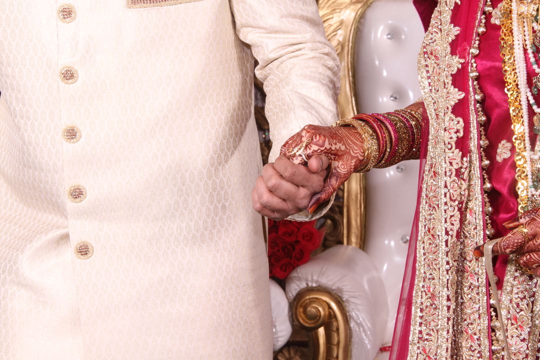 Close-Up of Indian Couple Holding Hands in Traditional Wedding Attire - Free Images, Stock Photos and Pictures on Pikwizard.com