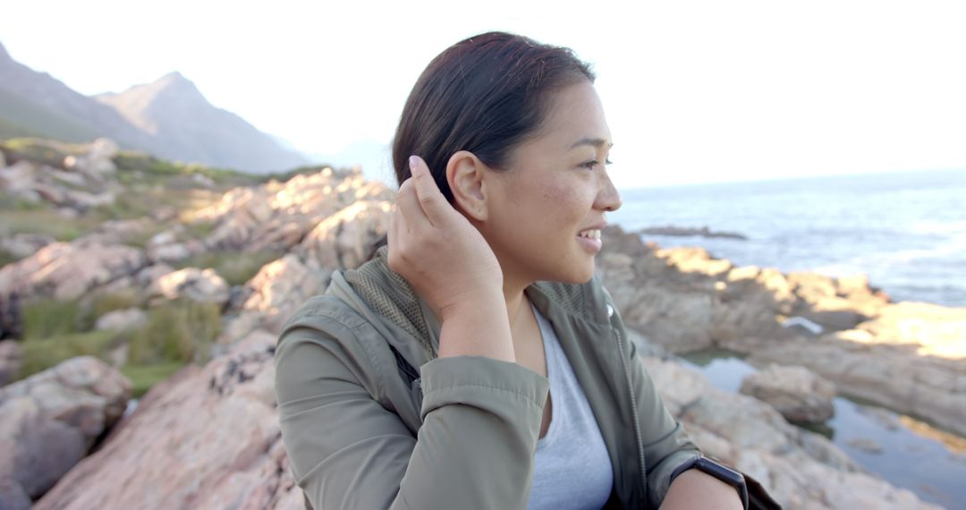 Woman Smiling on Mountain Hike by Ocean