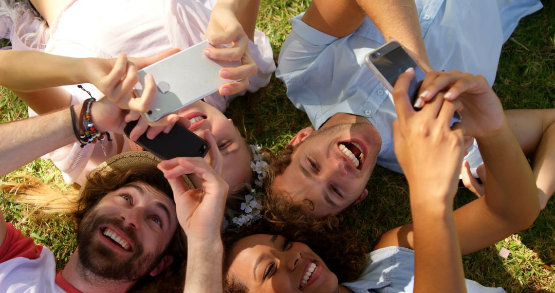 Friends Lying in Circle Enjoying Mobile Devices - Free Images, Stock Photos and Pictures on Pikwizard.com