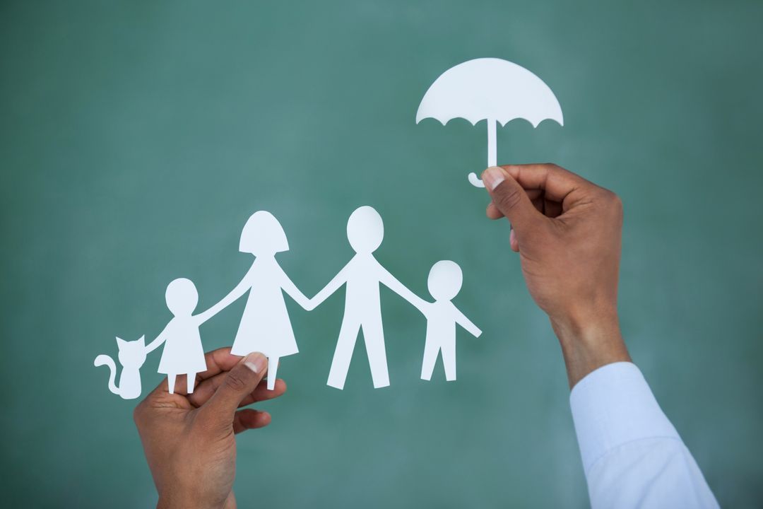 Man protecting paper cut out family with umbrella - Free Images, Stock Photos and Pictures on Pikwizard.com