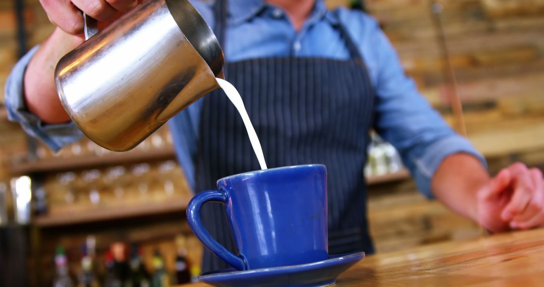 Barista pouring fresh milk into coffee cup - Free Images, Stock Photos and Pictures on Pikwizard.com