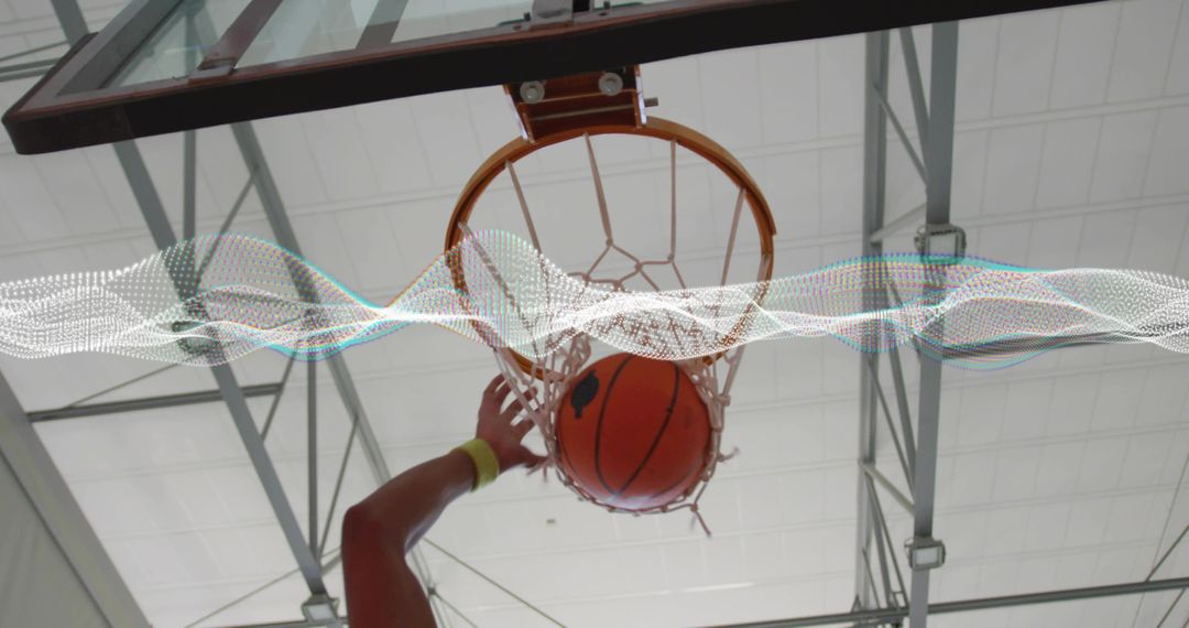 Basketball Player Scoring Dunk Indoors Under Stadium Lights