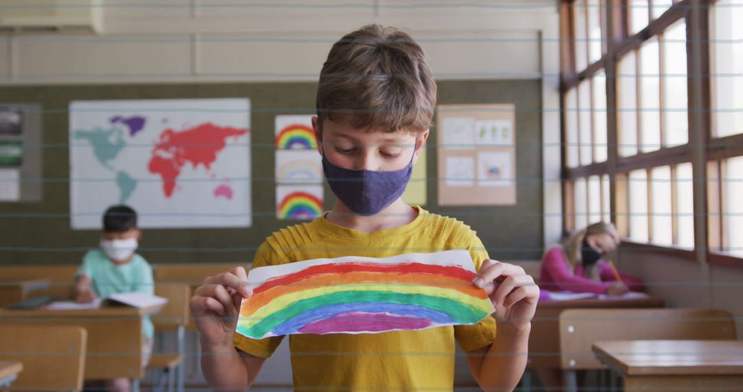 Child Showing Rainbow Drawing in Classroom Amidst New Normal - Free Images, Stock Photos and Pictures on Pikwizard.com