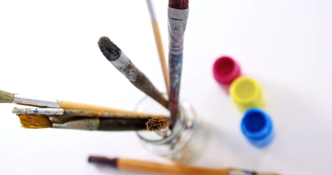 Collection of Well-used Paintbrushes in Jar with Bright Acrylic Paints - Free Images, Stock Photos and Pictures on Pikwizard.com