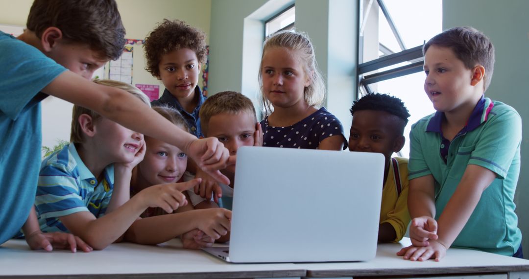 Group of Diverse School Children Engaging with Laptop in Classroom - Free Images, Stock Photos and Pictures on Pikwizard.com