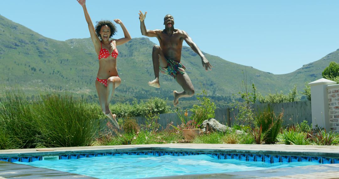 Front view of young black couple jumping in the swimming pool - Free Images, Stock Photos and Pictures on Pikwizard.com