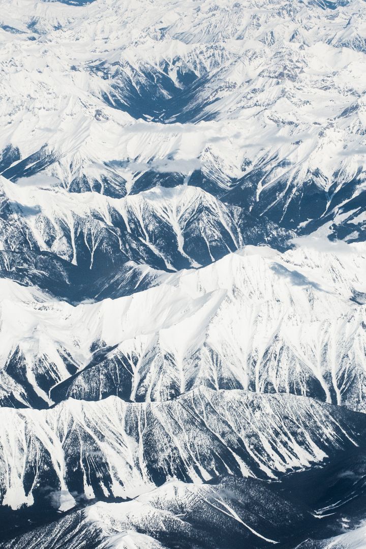 Aerial View of Snow-Covered Mountain Range in Winter - Free Images, Stock Photos and Pictures on Pikwizard.com