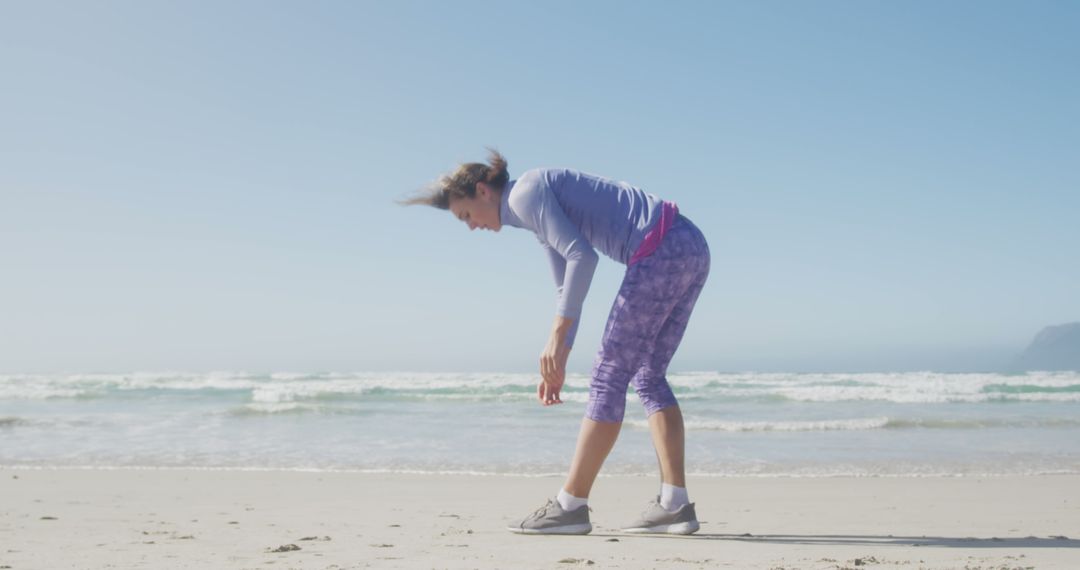 Woman Stretching on Sunny Beach for Morning Workout - Free Images, Stock Photos and Pictures on Pikwizard.com