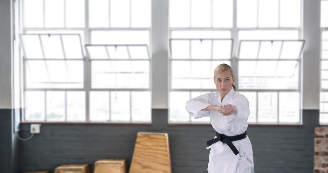Dedicated Martial Artist Practicing Karate Techniques in Gym