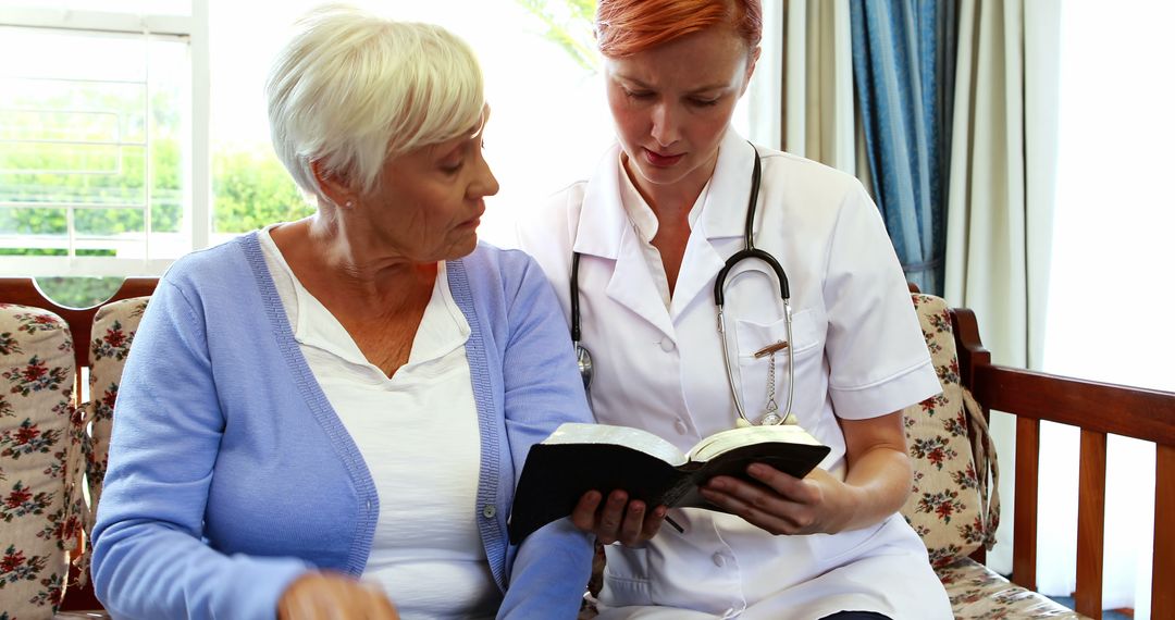 Nurse Reading with Elderly Woman in Cozy Living Room - Free Images, Stock Photos and Pictures on Pikwizard.com