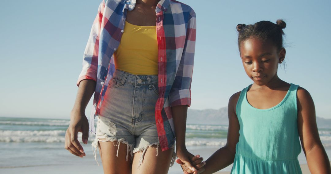 Mother and Daughter Walking Together on Sunny Beach - Free Images, Stock Photos and Pictures on Pikwizard.com