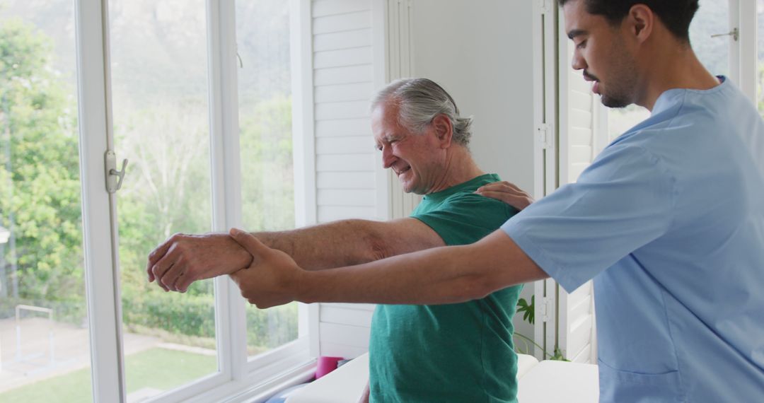 Physiotherapist Assisting Senior with Rehabilitation Exercises - Free Images, Stock Photos and Pictures on Pikwizard.com