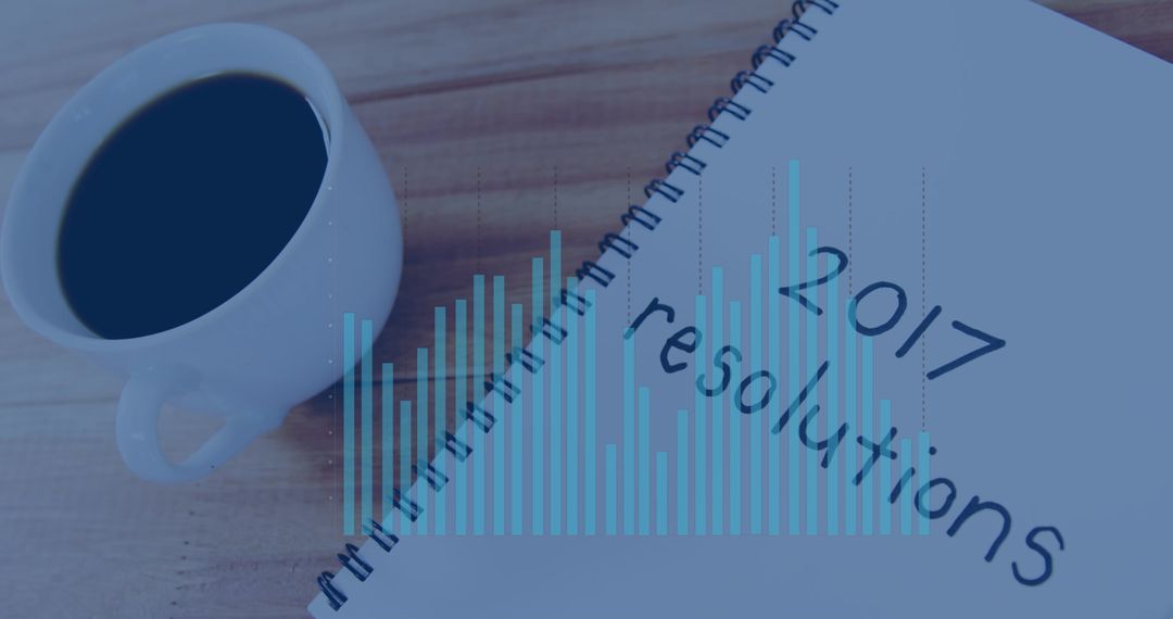 Notebook with 2017 Resolutions and Coffee Indicating Goal Planning