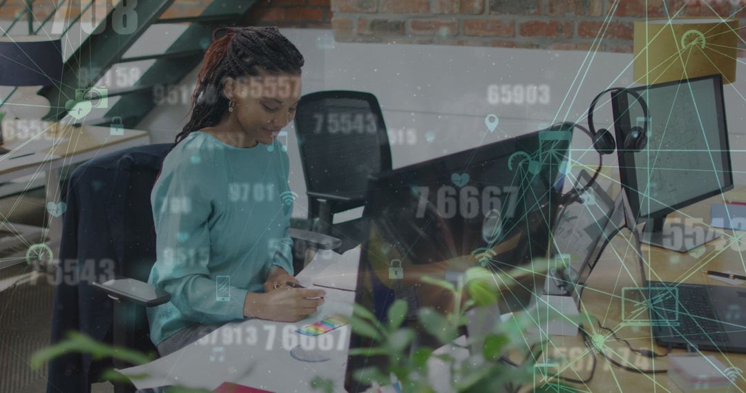 African American Professional Analyzing Data Networks in Modern Workspace