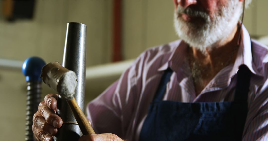 Elderly Craftsman Engaging in Ironwork - Free Images, Stock Photos and Pictures on Pikwizard.com