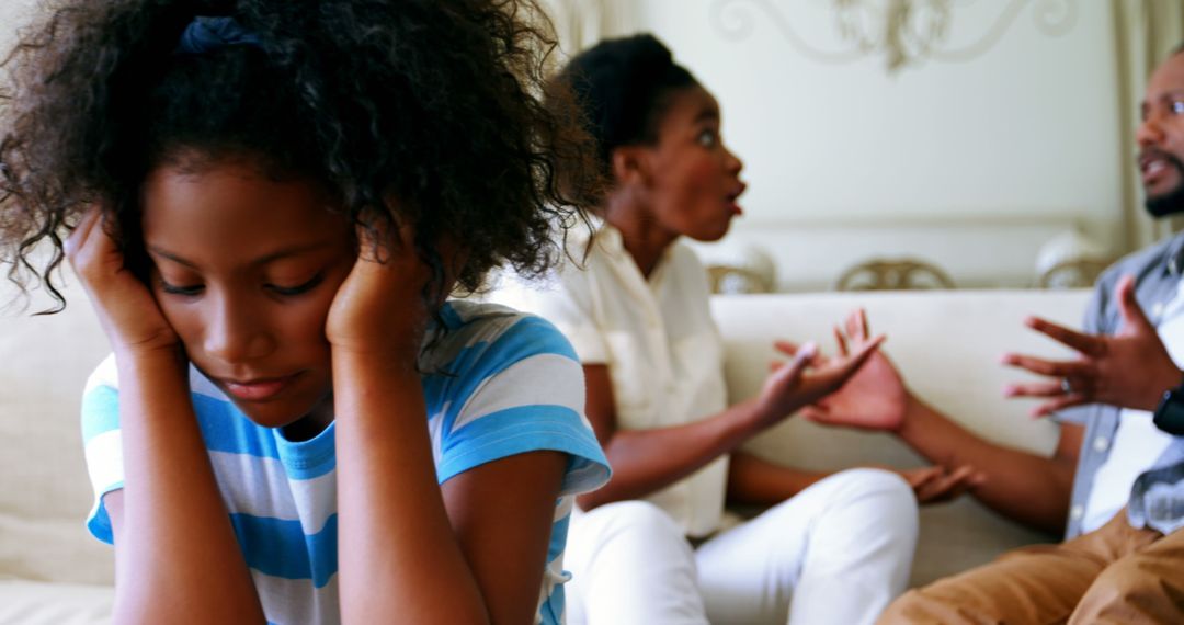 Young Girl Distraught While Parents Argue in Background - Free Images, Stock Photos and Pictures on Pikwizard.com