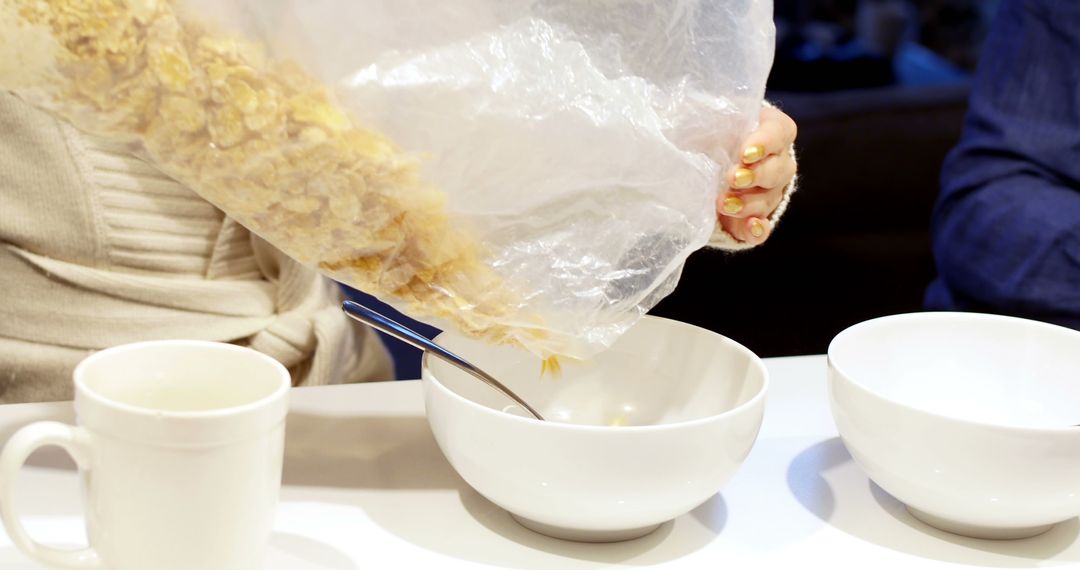 Woman Pouring Cornflakes Into Breakfast Bowl - Free Images, Stock Photos and Pictures on Pikwizard.com