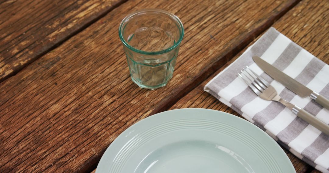 Empty Plate with Cutlery and Glass on Wooden Table - Free Images, Stock Photos and Pictures on Pikwizard.com