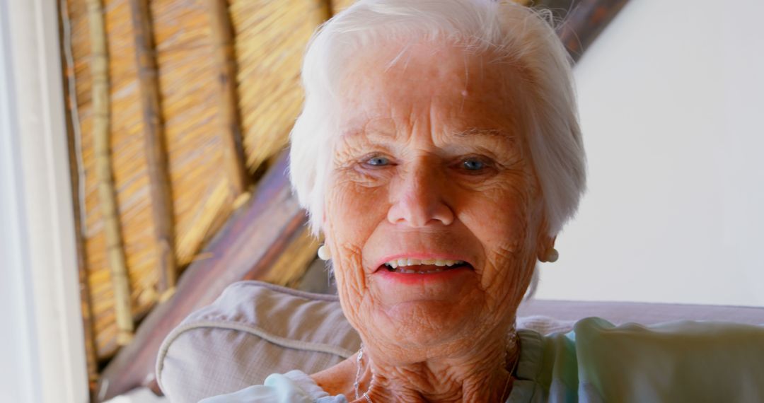 Close-Up Portrait of Happy Elderly Woman Sitting Indoors - Free Images, Stock Photos and Pictures on Pikwizard.com