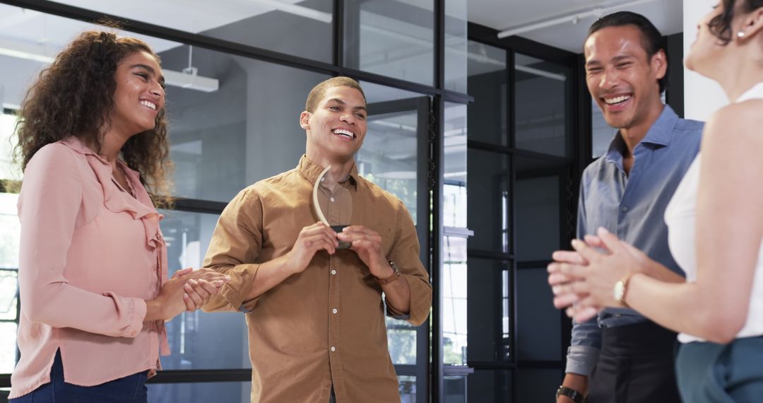 Celebrating Colleagues Exchanging Ideas and Congratulating at Office Award Ceremony