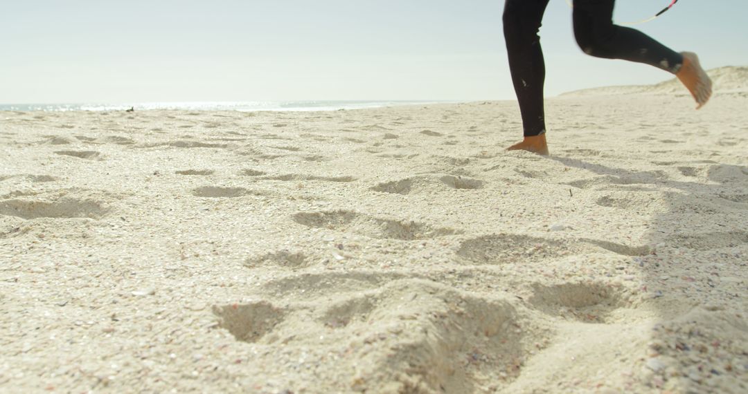 Person Jogging on Sandy Beach Under Clear Sky - Free Images, Stock Photos and Pictures on Pikwizard.com