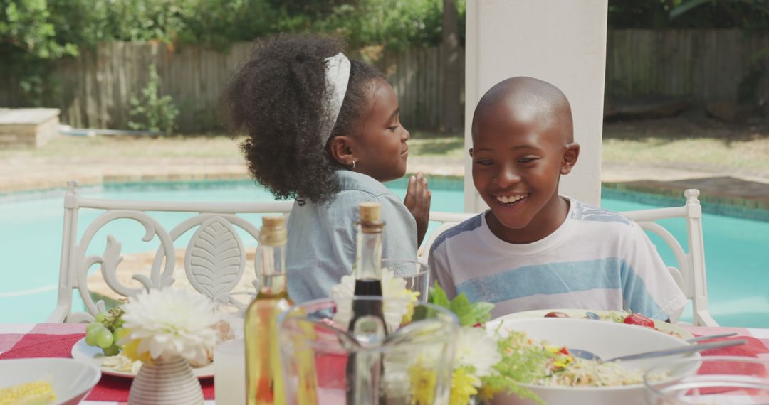 Joyful Siblings Dining by Poolside on Sunny Day