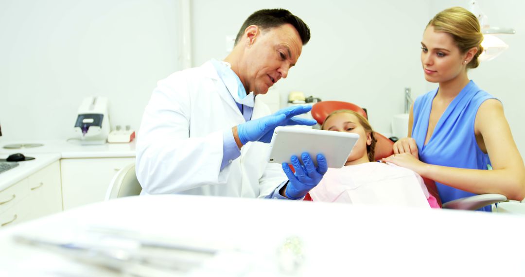 Dentist Explaining Procedure to Patient and Concerned Family Member - Free Images, Stock Photos and Pictures on Pikwizard.com