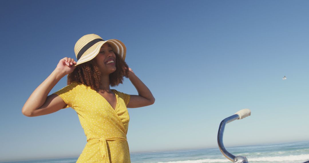 Cheerful Woman Wearing Yellow Dress Enjoying Beach Vacation - Free Images, Stock Photos and Pictures on Pikwizard.com