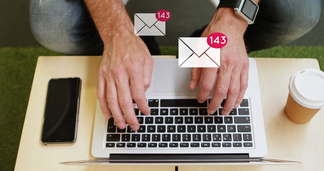 Man Checking Email Notifications on Laptop with Coffee