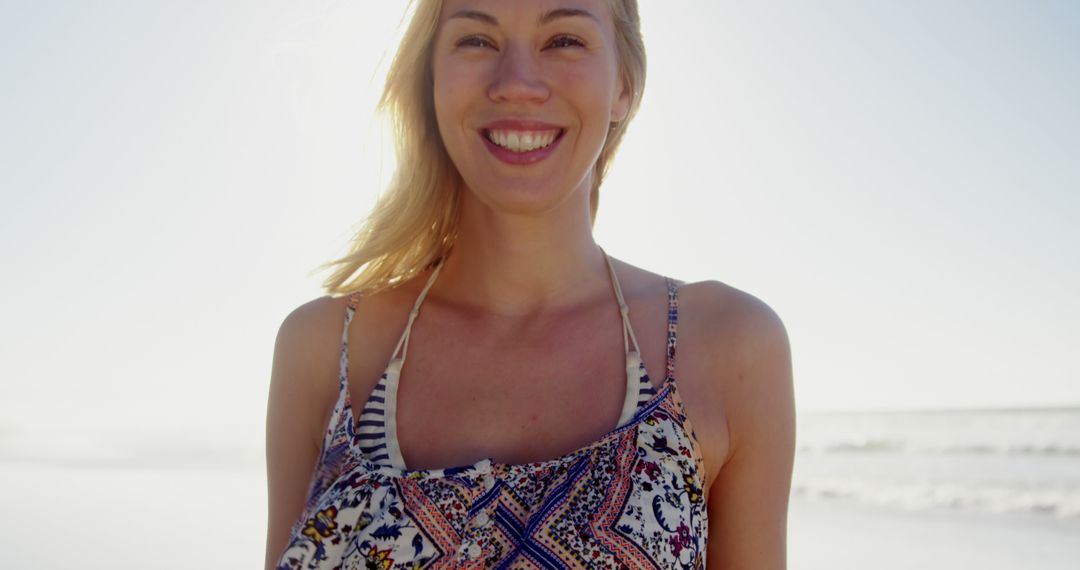 Smiling Woman Enjoying Beach on Sunny Day - Free Images, Stock Photos and Pictures on Pikwizard.com