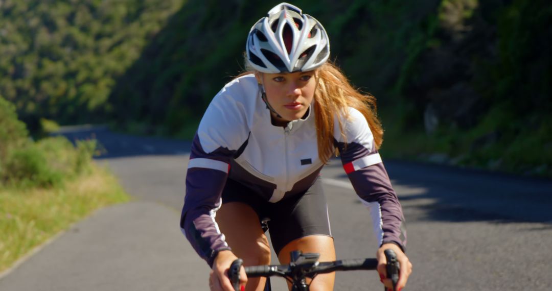 Focused Woman Cycling on Mountain Road - Free Images, Stock Photos and Pictures on Pikwizard.com