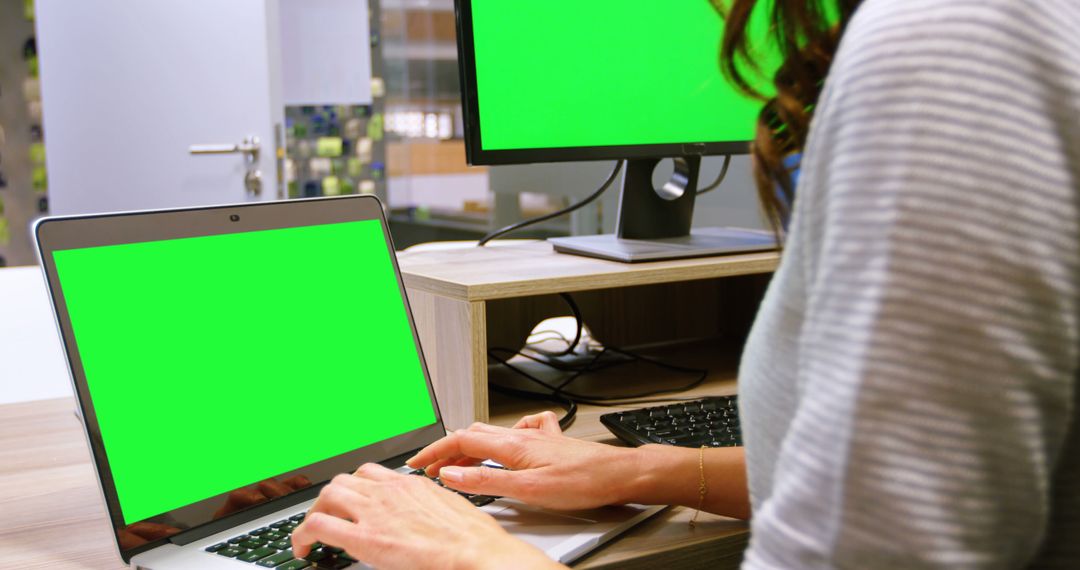 Person Working on Laptop with Green Screen in Modern Office - Free Images, Stock Photos and Pictures on Pikwizard.com