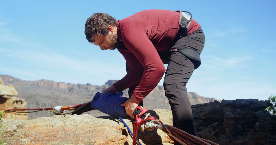 Male Rock Climber Securing Safety Ropes on Mountain - Free Images, Stock Photos and Pictures on Pikwizard.com