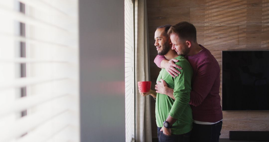 Loving Same-Sex Couple Embracing Near Sunlit Window at Home - Free Images, Stock Photos and Pictures on Pikwizard.com