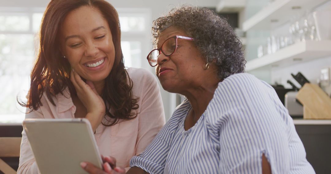 Smiling African American Women Using Tablet at Home - Free Images, Stock Photos and Pictures on Pikwizard.com