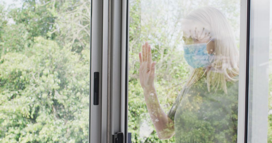 Elderly Woman With Face Mask Looking Out Window - Free Images, Stock Photos and Pictures on Pikwizard.com