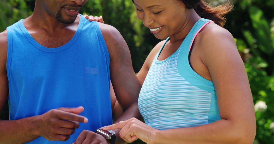 Couple Using Smartwatch during Outdoor Exercise - Free Images, Stock Photos and Pictures on Pikwizard.com