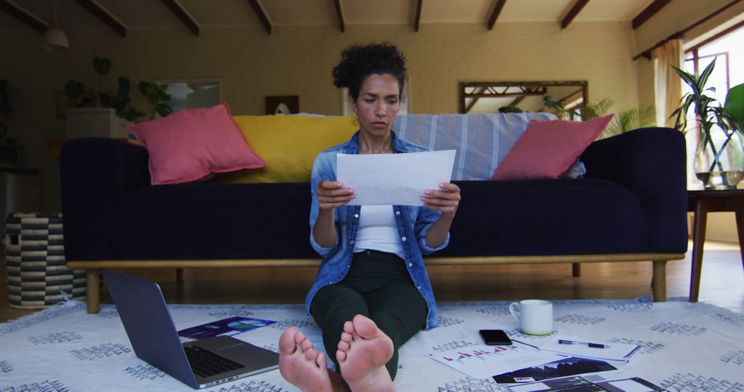 Woman Analyzing Financial Documents at Home - Free Images, Stock Photos and Pictures on Pikwizard.com