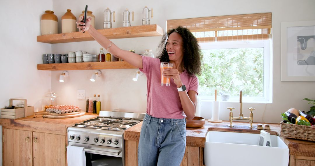 Woman in Rustic Kitchen Taking Selfie with Orange Juice