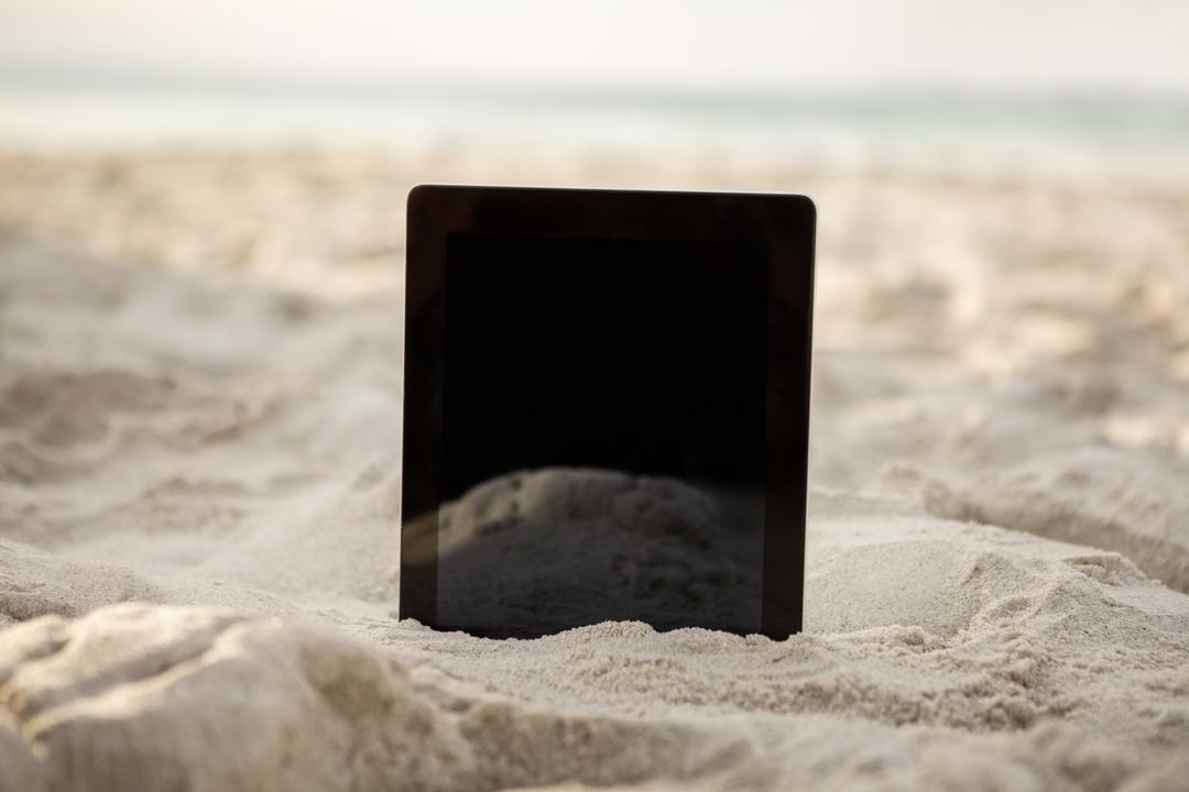 Digital tablet kept on sand - Free Images, Stock Photos and Pictures on Pikwizard.com